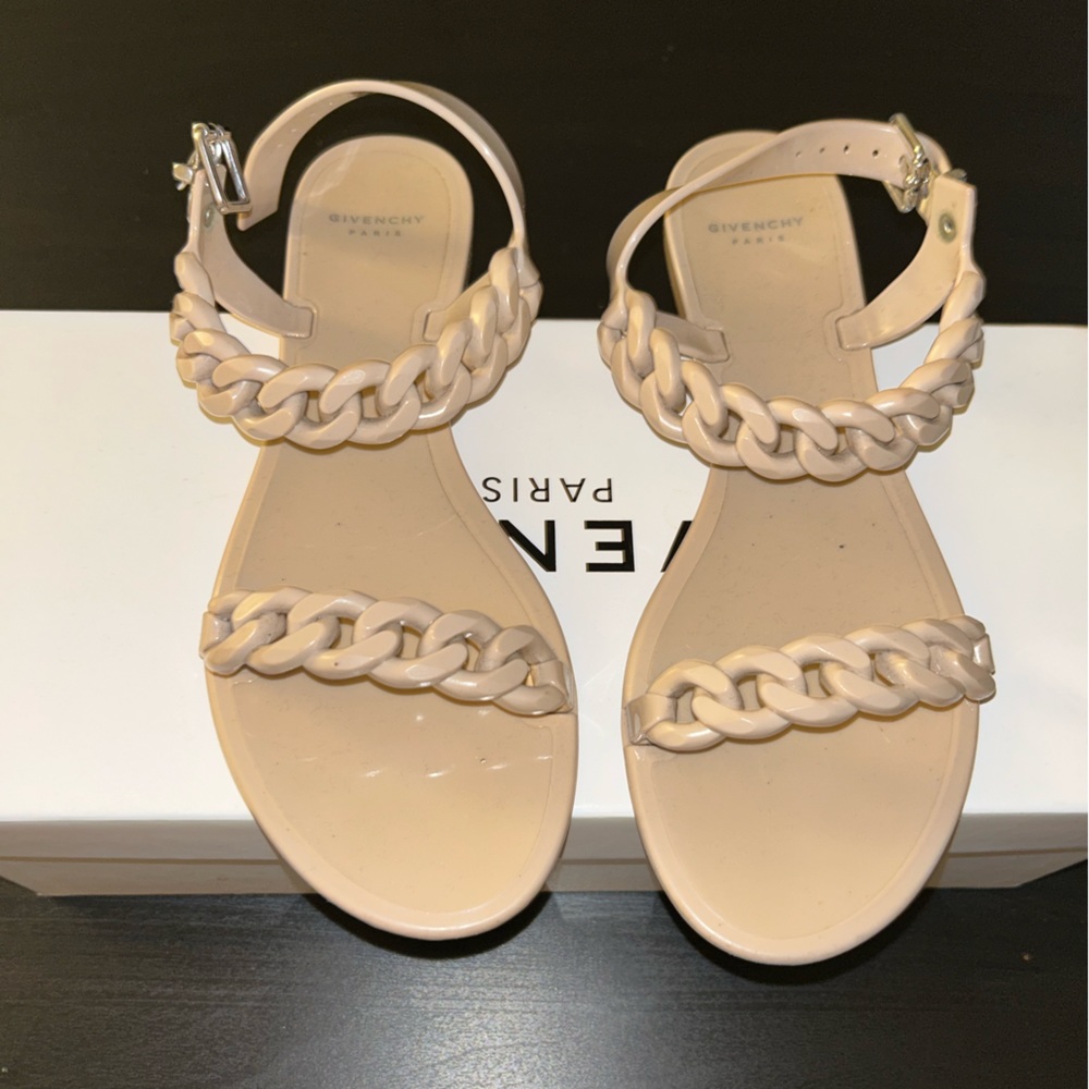 Givenchy Jelly sandals . Closure strap size 8
Worn . Fits true to size